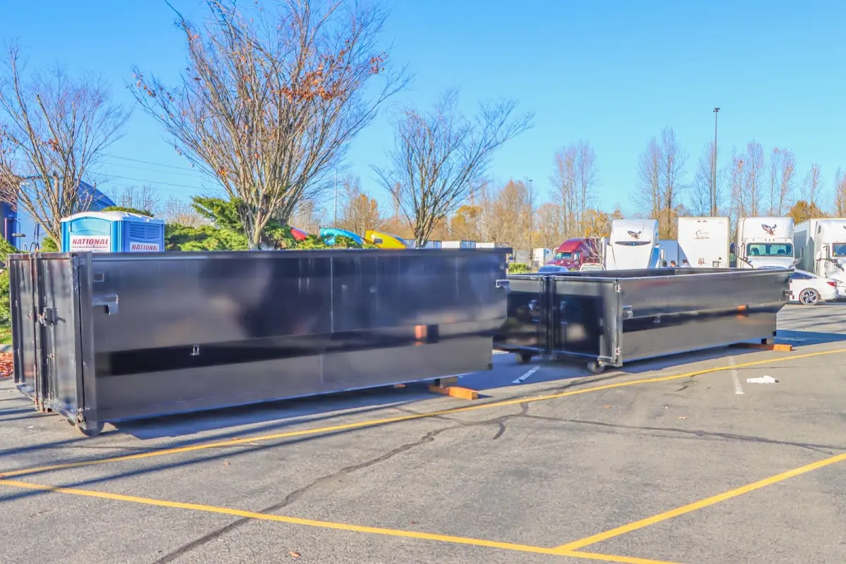 Professional dumpster rental service with roll-off container on residential driveway in Reidsville